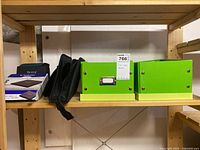 Photo showing two green metal storage boxes along with a zipped black CD/DVD carrying case and a boxed CD/DVD drive.