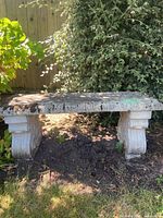 Full view of concrete bench outdoors under tree
