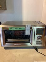 Front view of stainless steel Cuisinart Steam Convection Oven Plus with control panel and glass door closed. Dimensions marked on tape: 19.5 W x 14.5 D x 11 H.