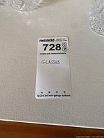 Lot tag with written note 'Glasses' and lot number label