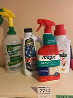 Close-up of cleaning spray bottles and bottles of cleaning chemicals on a surface