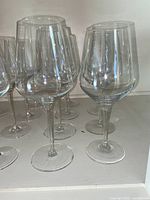 Front view of clear stemware with taller, narrow bowls showing multiple glasses in a row.