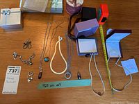Overview of entire lot showing various pieces of sterling silver jewelry including multiple necklaces, bracelets, earrings, and boxed jewelry cases