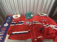 Overview of hockey apparel and caps including Montreal Canadiens jersey, jackets, and two caps