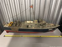 Front and side view of the large model military boat showing detailed deck and hull with number 2564 and measuring tape indicating approximately 3 feet long.