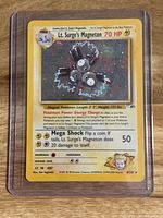 Front holographic side of Lt. Surge's Magneton Pokemon card showing detailed artwork and stats.