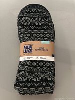 Single pair of Muk Luks men's slipper socks in original packaging, black and gray patterned, size L/XL.