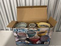 Top view of the box containing 6 mugs with varied patterns showing colors and designs.