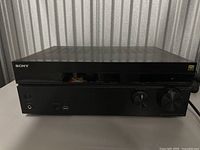 Front view of black Sony AV receiver showing the Sony logo and front panel controls