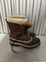 Pair of Sorel winter boots showing side profile with fleece lining.