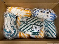 Box containing multiple factory-packaged bundles of striped socks