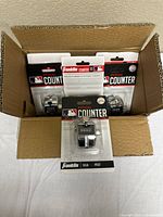 Open carton showing multiple Franklin pitch counters in packaging