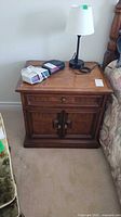 Front view of Drexel nightstand beside bed