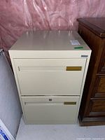 Front view of beige two-drawer metal filing cabinet