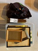 Plastic bin with assorted wooden and metal frames and carry bag