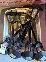 Tray containing six black solar stake lights