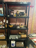 Full view of black plastic shelving unit with five shelves