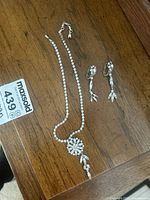 Necklace and earrings overview on wood surface