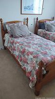 Twin pine bed frame with bedding shown (bedding excluded)