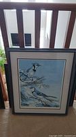Framed Vic Gibbons print showing artwork and frame
