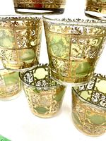 Stacked view of several Culver Valencia glasses showing gold lattice and green panels