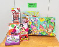 All items group shot showing Tech Deck, Slinky, three Happy Meal toy boxes, two puzzles