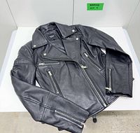 jacket laid flat to show front, zippers, lapel and pockets