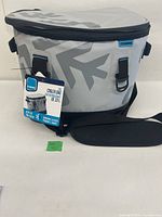 Front view of grey Movers cooler bag with shoulder strap and hang tag