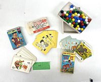 Overall lot with both card decks, booklet, mini packet and box of marbles visible