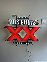 Front view illuminated Dos Equis neon sign
