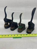 Front view showing all four embossing presses with ruler for scale