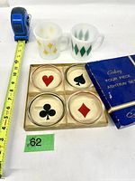 Overall lot: two Fire-King mugs, boxed Galaxy four-ashtray set, measuring tape for scale