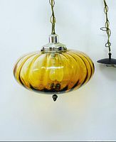 Full view of amber glass swag lamp with chain