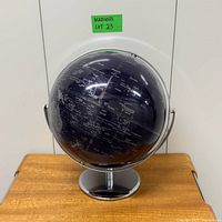 Front view of indigo blue globe on chrome pedestal