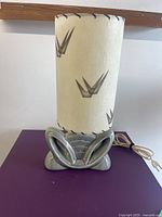 Front view of lamp showing base and shade