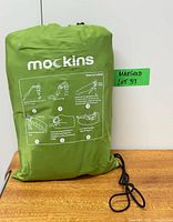 Front of green Mockins carry bag showing logo and inflation instructions