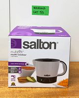 Retail box front showing Salton multi-cooker details