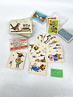 Assorted decks laid out showing various illustrated cards and plastic case