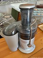 Full view of Breville JE98XL juicer with pulp container and locking arm