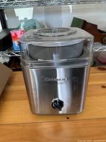 Front view of Cuisinart ICE-30 stainless steel ice cream maker with lid