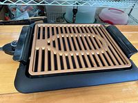 Grill assembled showing copper grill plate on black base