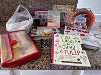 Overall view of craft kits, books, Wikki Stix binder, stamp, pens bag