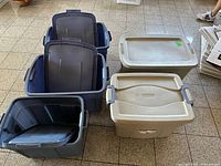 Six plastic storage totes with several lids positioned upright to show interior and exterior