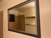 Front view of entire mirror hung on wall