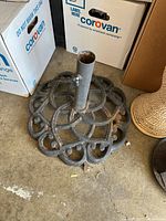 decorative cast iron umbrella stand on garage floor