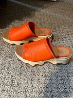 Side view of both sandals showing uppers and wave soles