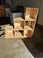 Front view of step-style shelf showing six open cubbies