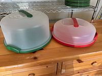 Both plastic carriers showing bases, domes, and latch mechanisms