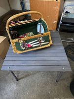 Picnic basket open showing interior contents strapped in place