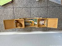 Accordion sewing box open showing compartments and contents